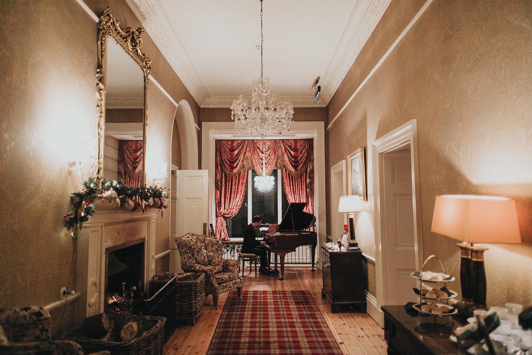 Joe Kenny playing baby grand piano In Tankardstown House, Co. Meath