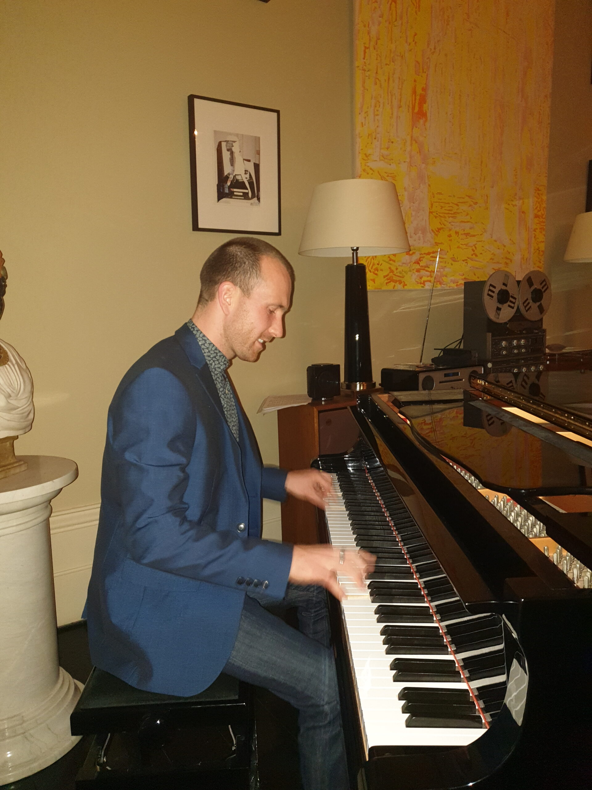 Joe Kenny playing baby grand piano In Tankardstown House Co Meath