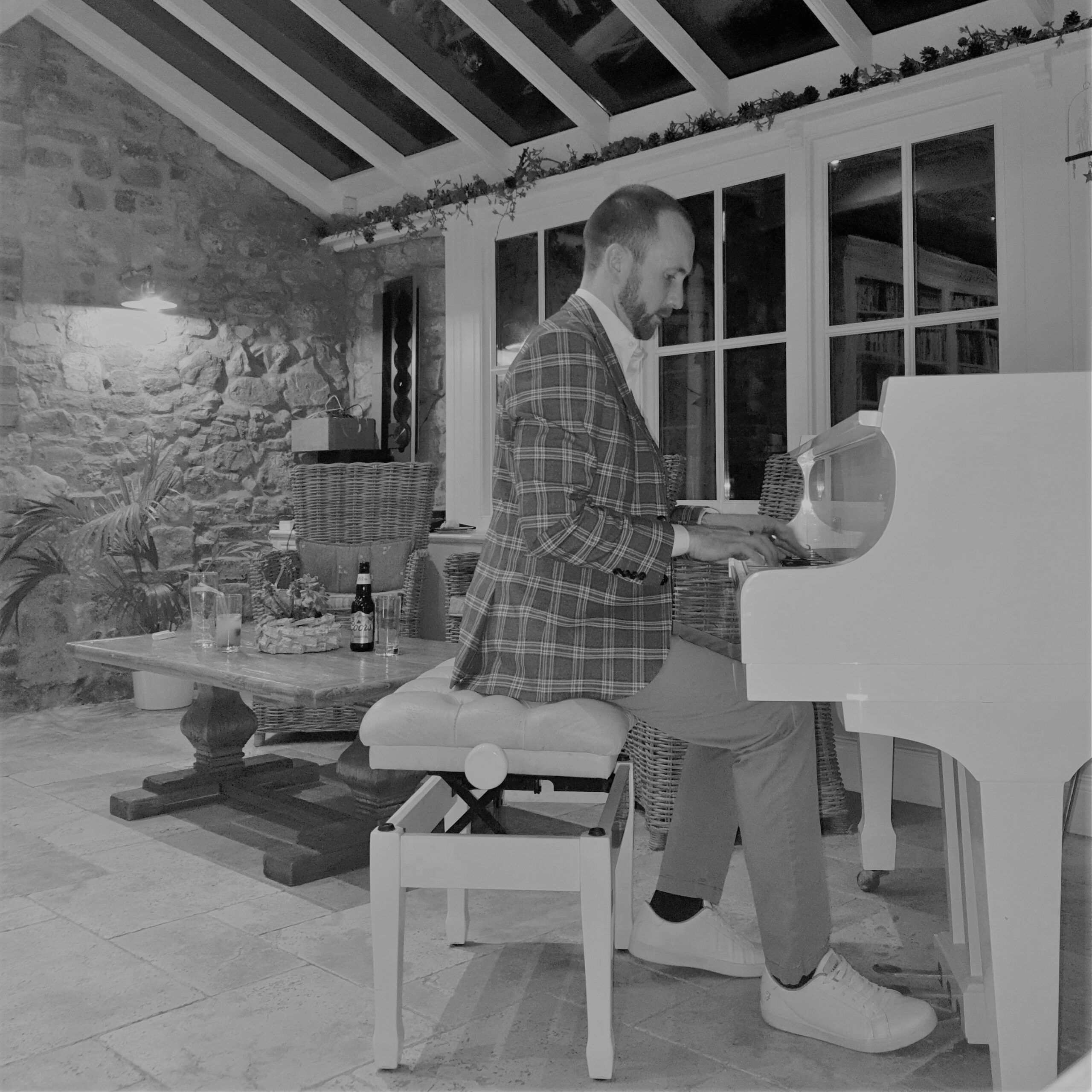 Joe Kenny playing grand piano in Ballymagarvey Village over wedding drinks reception