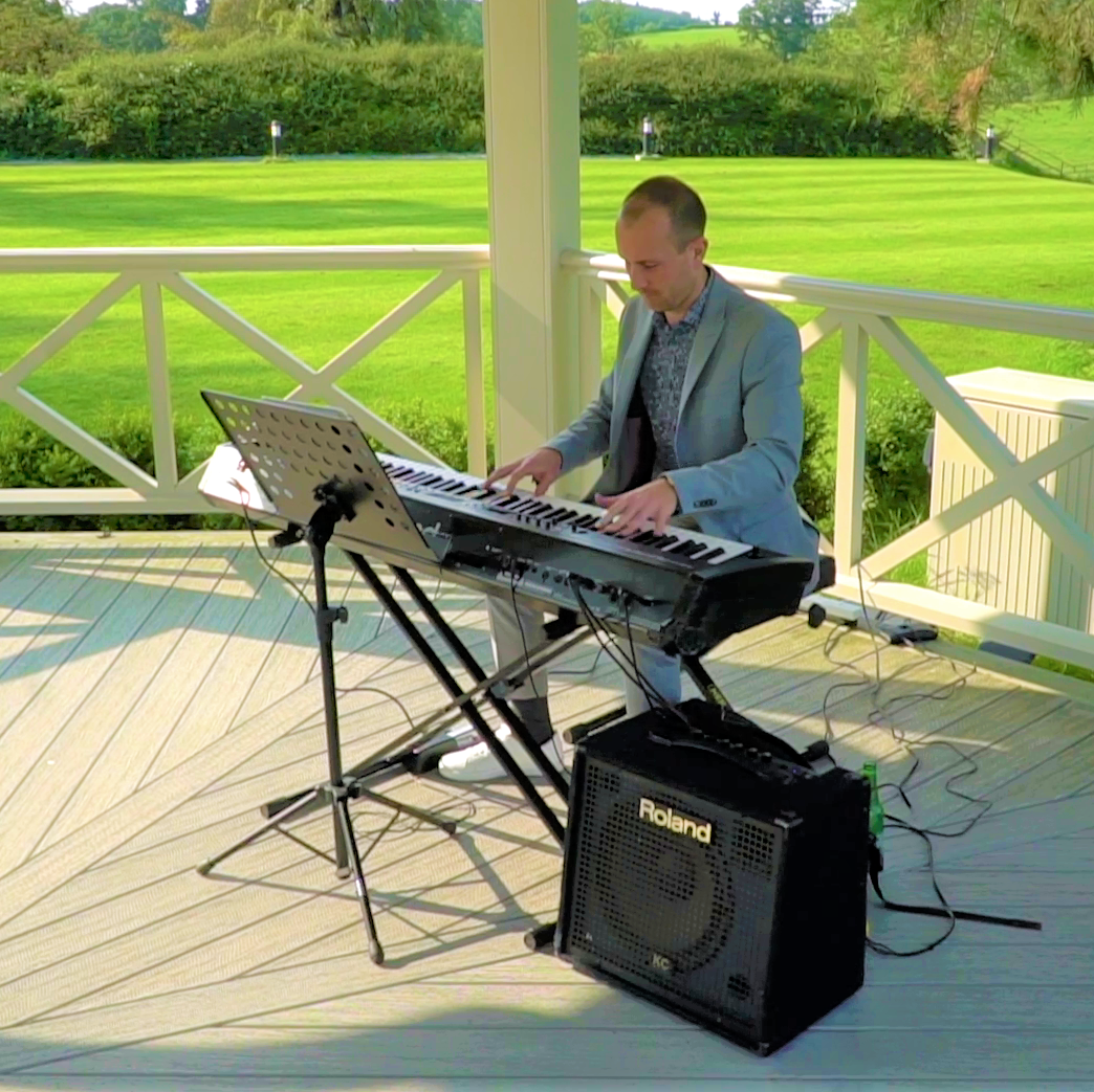 Joe Kenny playing grand piano over wedding drinks reception in Luttrellstown Castle, Co. Dublin